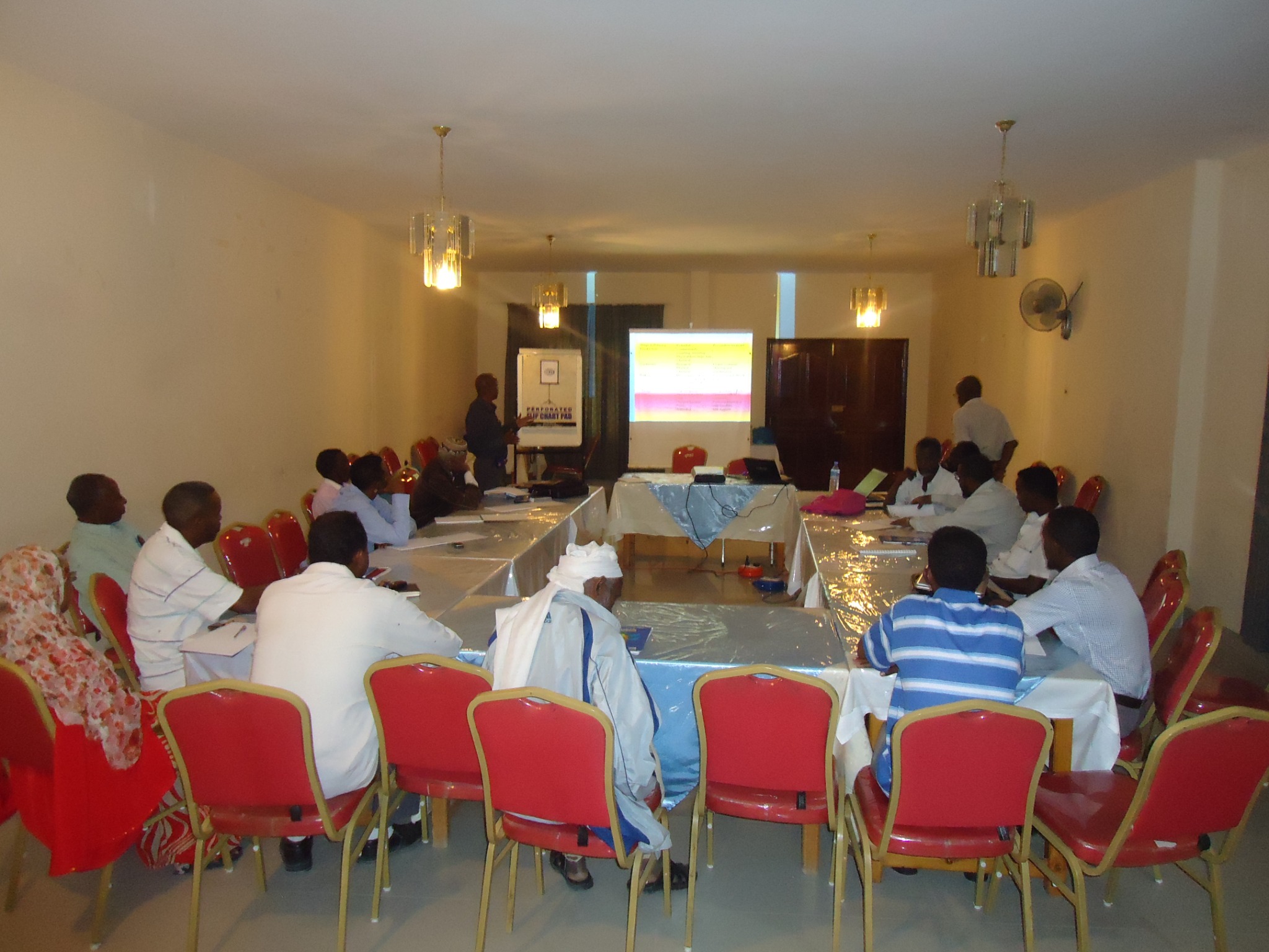 Workshop participants discussing a presentation around conference tables